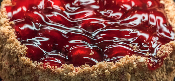 A cake with a crumbly pastry base filled with shiny icing