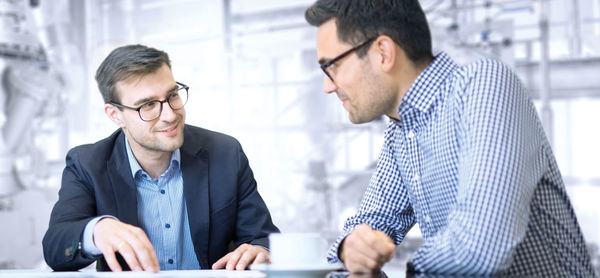 Two people at a table plan a system